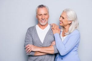 Older couple with dentures smiling