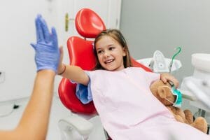 girl high fiving her hygienist