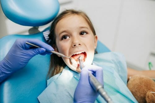 girl getting teeth cleaning