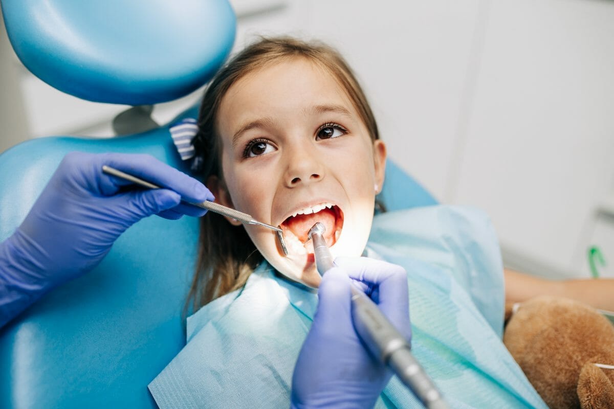 girl getting teeth cleaning