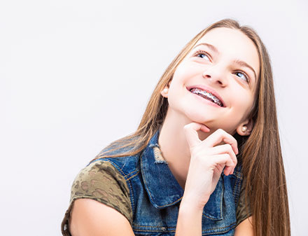 Young girl with braces smiling